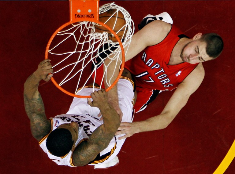  Cleveland Cavaliers' Alonzo Gee, left, dunks on Toronto Raptors' Jonas Valanciunas (17), of Lithuania, in the first half of an NBA basketball game, Tuesday, Dec. 18, 2012, in Cleveland. (AP Photo/Mark Duncan)  