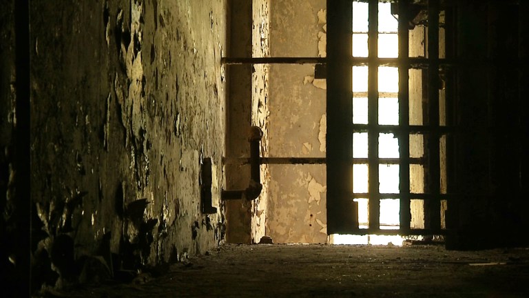 In this June 3, 2015, image taken from video, a hallway is shown in the old Meriwether County jail in Greenville, Ga. The jail, southwest of Atlanta, fell into disrepair after it closed in the mid-1980s. The 119-year-old relic of narrow, aged hallways and small, worn prison cells is being renovated into a home and museum. (AP Photo/Alex Sanz)