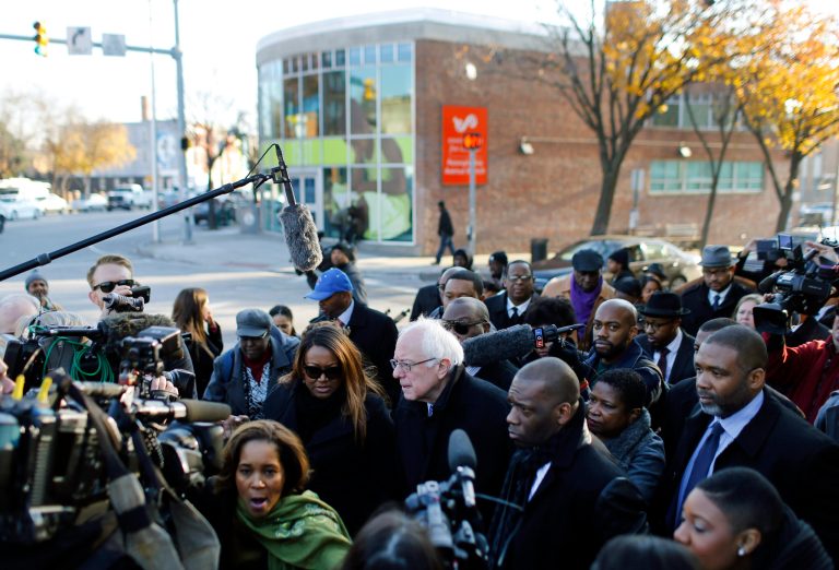 Democratic presidential candidate, Sen. Bernie Sanders, I-Vt., center, walks through the intersection of North and Pennsylvania Avenues, the site of unrest following the funeral of Freddie Gray, in Baltimore, Tuesday, Dec. 8, 2015. Sanders toured areas of unrest following Gray's funeral and met with African-American civic and religious leaders to discuss issues affecting the African-American community. (AP Photo/Patrick Semansky)