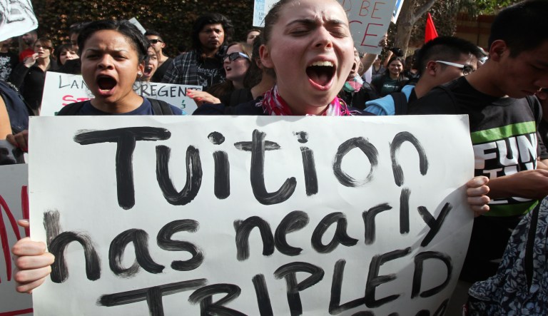 Colleges and universities need to take a hard look at reducing costs, not merely promising tuition freezes while raising the cost of fees and other items. (AP Photo/Reed Saxon, File)
