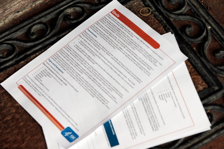 An informational flyer about Ebola from the Center for Disease Control is left of the front porch of a home Sunday, Oct. 12, 2014, in Dallas. A healthcare worker who lives on the street and who was caring for Ebola patient Thomas Eric Duncan, tested positive for the virus and is in stable condition, health officials said. If the preliminary diagnosis is confirmed, it would be the first known case of the disease being contracted or transmitted in the U.S.  (AP Photo/Brandon Wade)