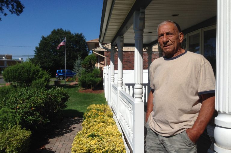 In this Aug. 13, 2014 photo, Jerry Baggetta poses for a photo outside his home in Commack, N.Y., on New York's Long Island. Baggetta is among a group of Commack residents opposing a proposal to bring as many as 40 unaccompanied immigrant children to be housed at the nearby Holy Cross Lutheran Church. (AP Photo/Frank Eltman)