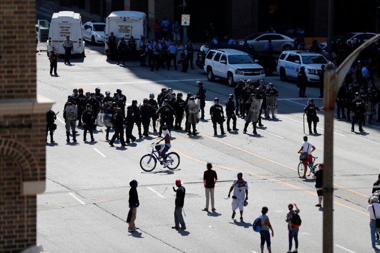 Police in the riot gear guard the streets as protesters gather outside of the courthouse, Friday, Sept. 15, 2017, in downtown St. Louis, after a judge found a white former St. Louis police officer, Jason Stockley, not guilty of first-degree murder in the death of a black man, Anthony Lamar Smith, who was fatally shot following a high-speed chase in 2011. (AP Photo/Jeff Roberson)