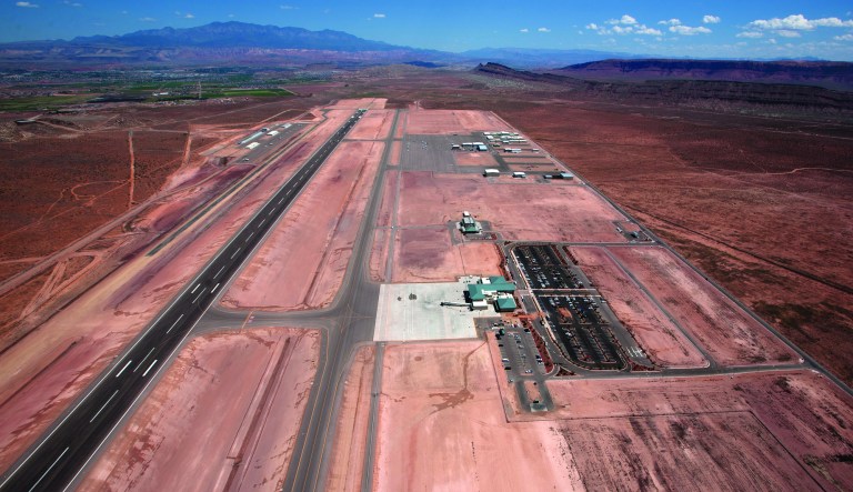 An aerial view shows the St. George Municipal Airport Tuesday, July 17, 2012. A SkyWest Airlines employee wanted in a murder case attempted to steal a passenger plane, then shot himself in the head after crashing the aircraft in a nearby parking lot, officials said Tuesday. Brian Hedglin, 40, scaled a razor wire fence at the St. George Municipal Airport early Tuesday, then boarded the 50-passenger SkyWest jet while the airport was closed, St. George city spokesman Marc Mortenson said. (AP Photo/The Spectrum, Jud Burkett) NO SALES