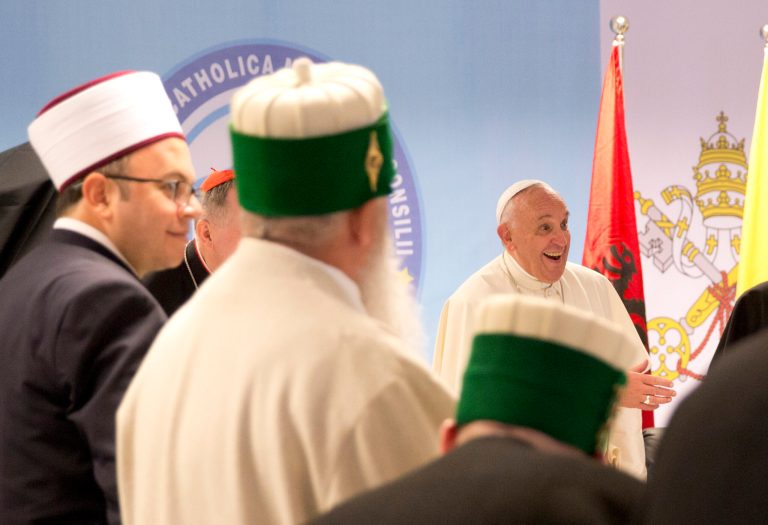 Pope Francis, right, arrives for a meeting with representatives of Albania's Muslim, Orthodox and Catholic communities, at the Catholic University 