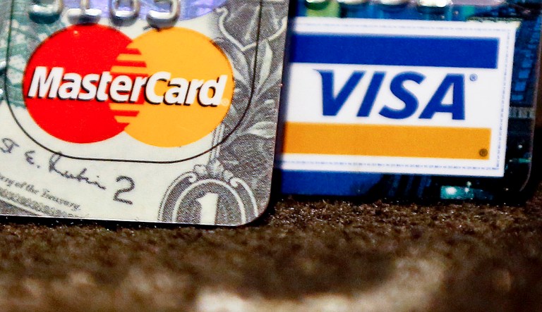 The average household owes a record $8,600, which is more than the peak during the recession. (AP Photo/Keith Srakocic)