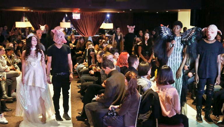 Cheyenne Jacobs, second from right, speaks as she stands next to a male model costumed as a pig during the #MeToo fashion show during Fashion Week in New York. (AP Photo/Bebeto Matthews)