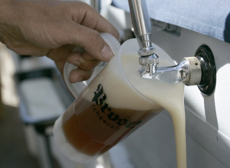 FILE - In this Aug. 24, 2008, file photo, Snowbird staffer Joe Waugh of Sandy, Utah, pours a beer during Oktoberfes in Snowbird, Utah. The beer will flow at a Utah Oktoberfest, after the state liquor board backed off its warning that the German celebration of all things ale could go dry this year. Utah's state liquor board on Tuesday, June 24, 2014 voted unanimously to grant a license for Snowbird Ski Resort's 12-week event now in its fourth decade. (AP Photo/The Salt Lake Tribune, Jim Urquhart, File)  DESERET NEWS OUT; LOCAL TV OUT; MAGS OUT