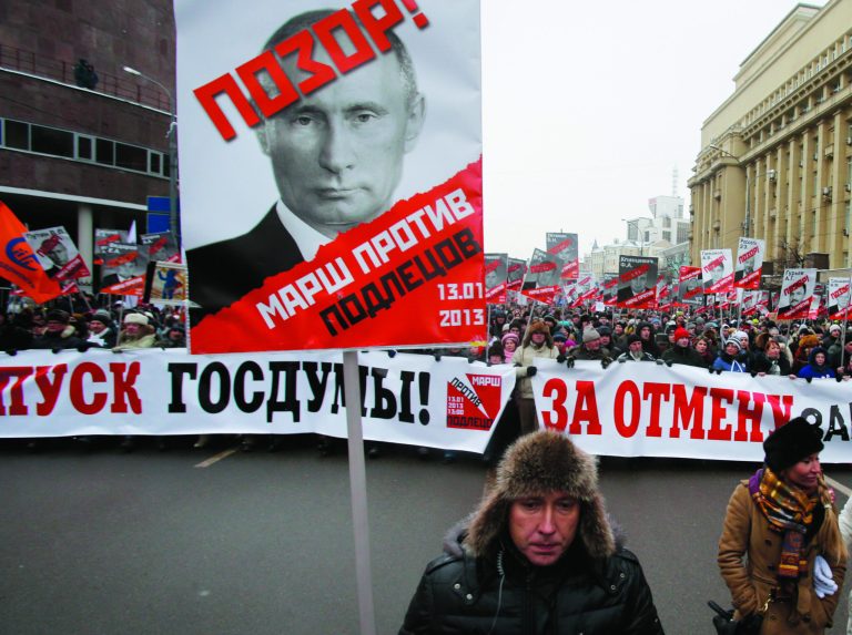 People carry posters of Russian President Vladimir Putin with the words reading 