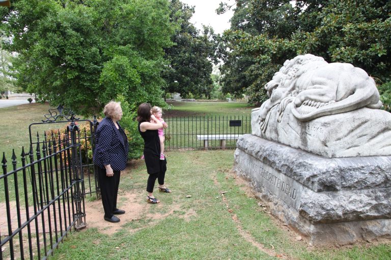 Janice Reed, her daughter Nancy Reed Morris, and her granddaughter Megan Morris, from left, visit the Confederate unknown soldier monument at Historic Oakland Cemetery while taking a Battle of Atlanta mobile app tour Friday, July 18, 2014, in Atlanta. Emory University's Center for Digital Scholarship released a web-based, GPS enhanced app for mobile devices to honor the 150th anniversary of the Battle of Atlanta. The app is a tour of the 12 most significant battle events that began July 22, 1864. (AP Photo)