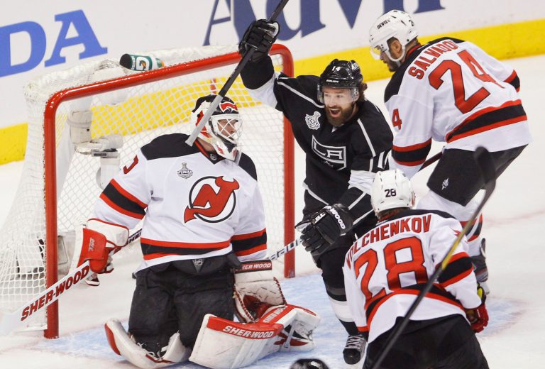   Los Angeles Kings right wing Justin Williams (14) reacts after Los Angeles Kings right wing Dustin Brown (23) scored his first goal past New Jersey Devils goalie Martin Brodeur (30) as New Jersey Devils defenseman Bryce Salvador (24) and New Jersey Devils defenseman Anton Volchenkov (28)look on in the first period during Game 6 of the NHL hockey Stanley Cup finals,Monday, June 11, 2012, in Los Angeles. (AP Photo/Jae C. Hong)  