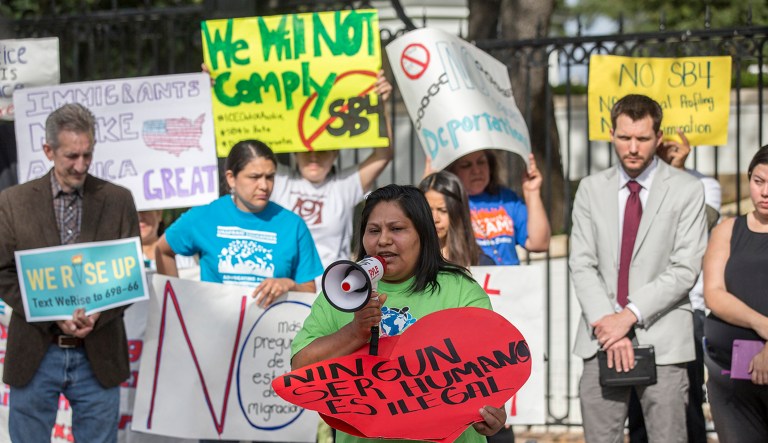 People protest outside the Texas Governor's Mansion after the Texas Republican Gov. Greg Abbott signed a law that would allow police to ask about an individual's immigration status. (Ricardo B. Brazziell/Austin American-Statesman via AP)