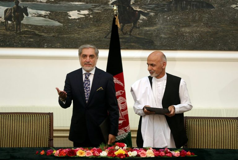 Afghanistan's presidential election candidates Abdullah Abdullah, left, and Ashraf Ghani Ahmadzai, right, prepare to leave after signing a power-sharing deal at the presidential palace in Kabul, Sunday, Sept. 21, 2014. (AP Photo/Massoud Hossaini)
