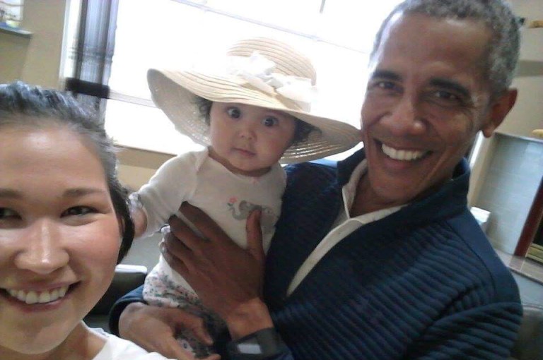 In this July 3, 2017 photo provided by Jolene Jackinsky, former U.S. President Barack Obama holds Jackinsky's 6-month-old baby girl while posing for a selfie with the pair at a waiting area at Anchorage International Airport, in Anchorage, Alaska. (Jolene Jackinsky via AP)