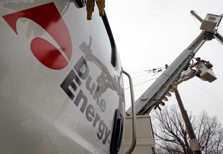 FILE - In this Feb. 14, 2012 file photo, Duke Energy employees work on power lines in Charlotte, N.C. Duke Energy Corp. reports quarterly earnings on Tuesday, Feb. 18, 2014. (AP Photo/Chuck Burton, File)