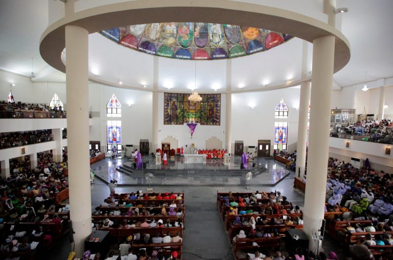 Catholics attend a Mass to celebrate Good Friday in Abuja, Nigeria, Friday, April 18, 2014. Nigerian Catholics joined Christians around the world in celebrating Holy Week ahead of Easter Sunday. (AP Photo/Sunday Alamba)