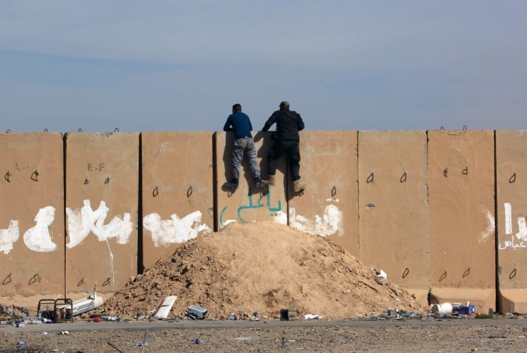 In this Friday, March 27, 2015 file photo, Iraqi soldiers watch movements of their enemy at the front line during clashes between Iraqi security forces and Islamic State group extremists in Tikrit, 130 kilometers (80 miles) north of Baghdad, Iraq. (AP Photo/Khalid Mohammed, File)