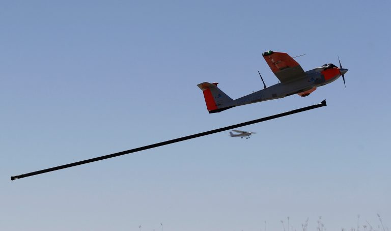 FILE - This Jan. 15, 2014, file photo shows a test drone as it is is launched by catapult as a trail plane follows on a ranch near Sarita, Texas. Model aircraft hobbyists, research universities and commercial drone operators and investors have filed lawsuits challenging a government directive that they say imposes tough new limits on the use of model aircraft and broadens a ban on commercial drone flights. (AP Photo/Eric Gay, File)