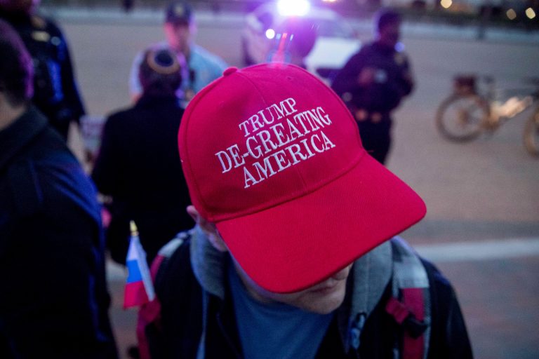 A man wears a hat that reads 