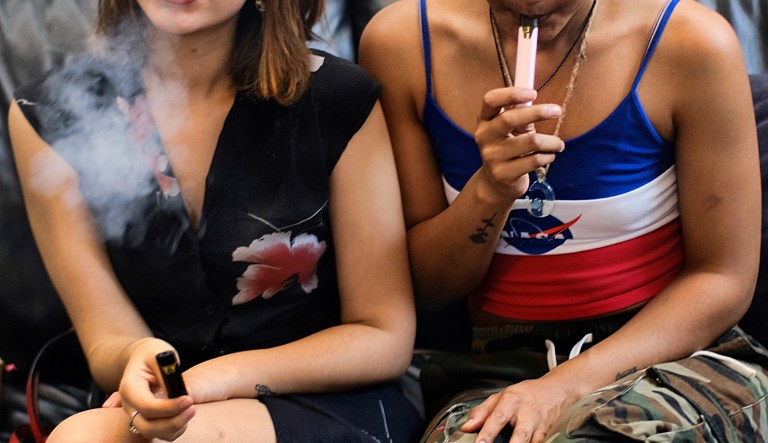 In this Saturday, June 8, 2019 file photo, two women smoke cannabis vape pens at a party in Los Angeles.