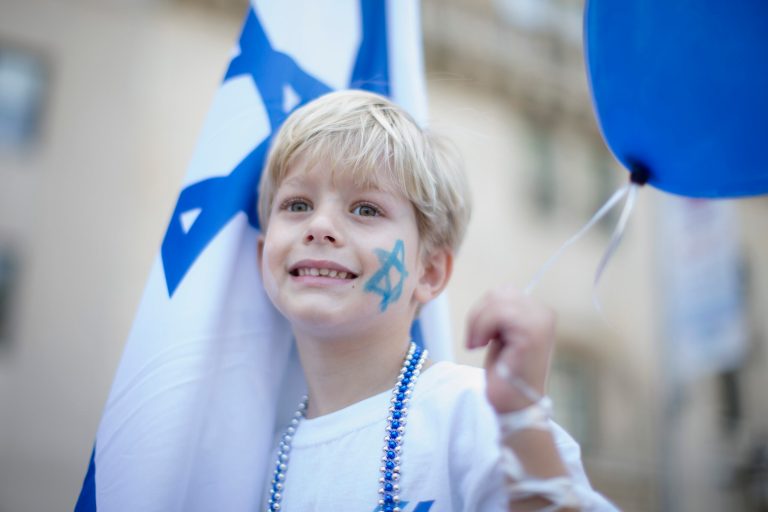 Maaydn Shmid, of Israel, smiles as he participates in the Celebrate Israel Parade, Sunday, June 1, 2014, in New York. Among the 35,000 marchers were New York Gov. Andrew Cuomo, New York City Mayor Bill de Blasio, Israeli diplomats and members of the Knesset, Israel's parliament. (AP Photo/John Minchillo)