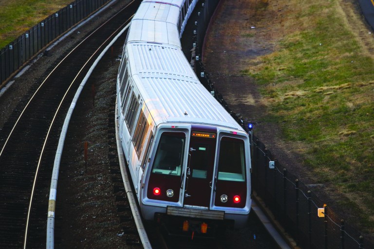 Metro train comes close to hitting two workers