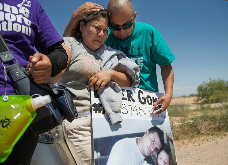 Anselma Lopez, is consoled by Miguel Guerra outside the immigration detention center in Eloy, Ariz., during a protest of the record numbers of deportations that have taken place under President Obama's administration on Saturday, April 5, 2014. Anselma Lopez, has been fighting to bring home her son, Elder Gomez-Lopez, who has been at Eloy Detention Center for the past 2 1/2 years. (AP Photo/The Arizona Republic,Nick Oza)