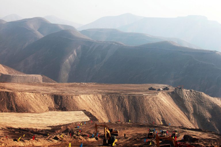 In this photo taken Monday Dec. 10, 2012, earth moving vehicles are seen in Baidaoping area in Lanzhou in northwest China's Gansu province. China's campaign to shave off mountaintops and fill in valleys to make way for cities may come at too high a price in the pollution, erosion and flooding unleashed by the unprecedented redistribution of earth, Chinese researchers warned Thursday June 5, 2014. (AP Photo) CHINA OUT