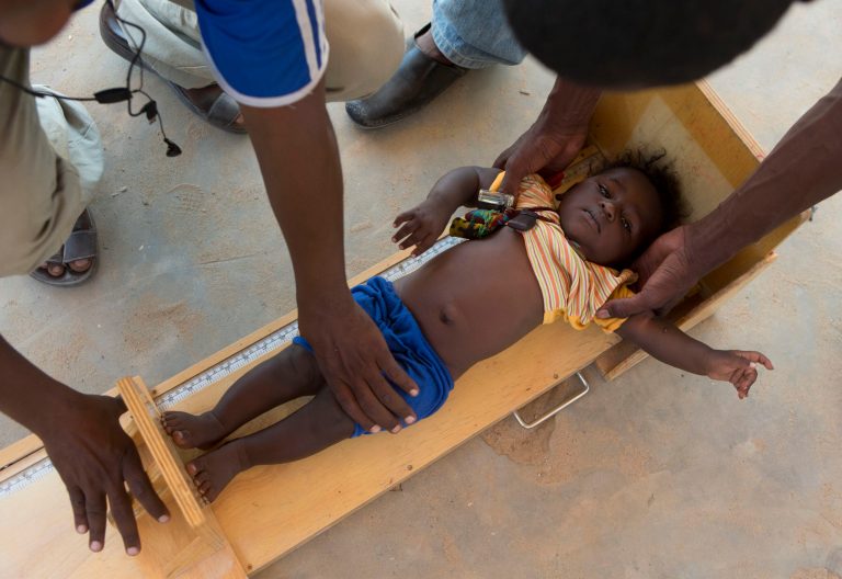  In this Nov. 4, 2012 photo, health workers measure the height of a boy during a mobile clinic to identify cases of underweight, stunted, or malnourished children, in Michemire, in the Mao region of Chad. A survey conducted in the county found that 51.9 percent of the children are stunted, one of the highest rates in the world, according to a summary published by UNICEF. Stunting is the result of having either too few calories, too little variety, or both. (AP Photo/Rebecca Blackwell)  