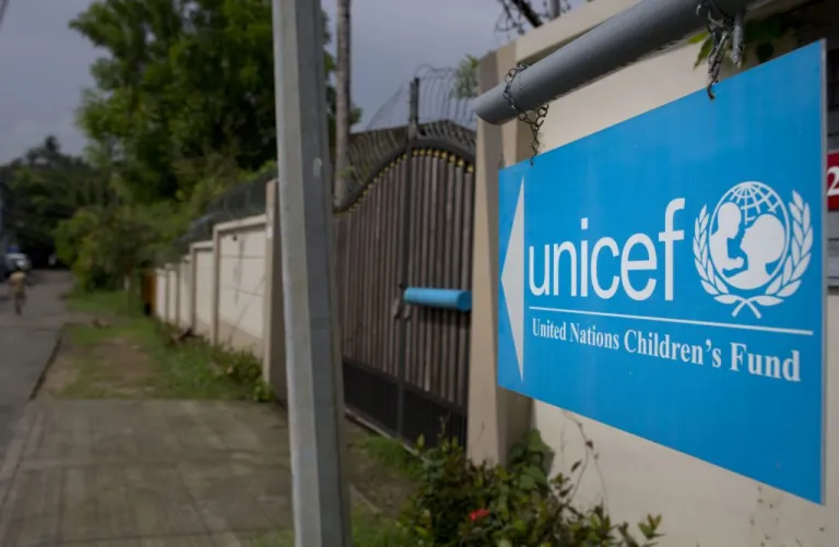 A newly placed sign board gives directions to the office of United Nations' children's agency.