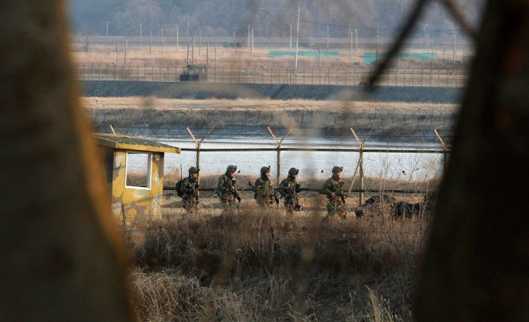 South Korean army soldiers patrol along a barbed-wire fence near the border village of Panmunjom in Paju, South Korea, Wednesday, March 27, 2013. North Korea said Wednesday that it had cut off a key military hotline with South Korea that allows cross border travel to a jointly run industrial complex in the North, a move that ratchets up already high tension and possibly jeopardizes the last major symbol of inter-Korean cooperation.(AP Photo/Ahn Young-joon)