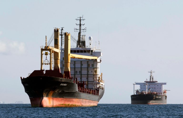   In this Friday, June 28, 2013 photo, the container ship Baghira, foreground, and the oil tanker Seabulk Arctic, rear, are anchored off shore as they wait to enter Port Everglades in Fort Lauderdale, Fla. The government reports on the U.S. trade deficit for June on Tuesday, Aug. 6, 2013. AP Photo/Wilfredo Lee)  