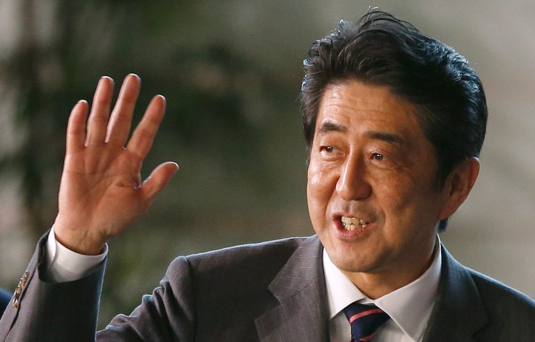   Japan's newly-named Prime Minsiter Shinzo Abe smiles as he waves at the media upon his arrival at the prime minister's official residence following his election at Parliament in Tokyo Wednesday, Dec. 26, 2012. Abe, whose nationalist positions have in the past angered Japan's neighbors, is the country's seventh prime minister in just over six years. (AP Photo/Shizuo Kambayashi)  