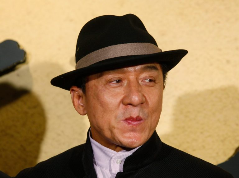   Hong Kong movie star Jackie Chan poses for photographers during the charity premiere of his new movie 