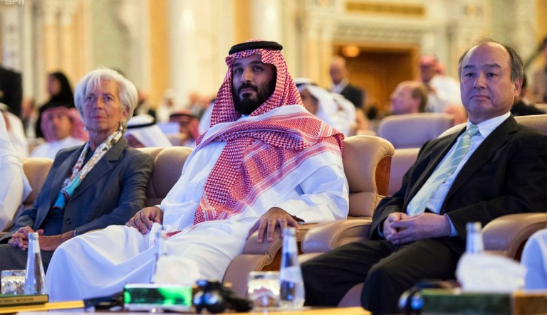 In this photo released by Saudi Press Agency, SPA, Saudi Crown Prince Mohammed bin Salman, center, and Managing Director of the International Monetary Fund Christine Lagarde, left, attend the opening ceremony of Future Investment Initiative Conference in Riyadh, Saudi Arabia, Tuesday, Oct. 24, 2017. Saudi Arabia's powerful crown prince on Tuesday announced plans to build a futuristic city run entirely on alternative sources of energy and said the ultraconservative kingdom must return to 