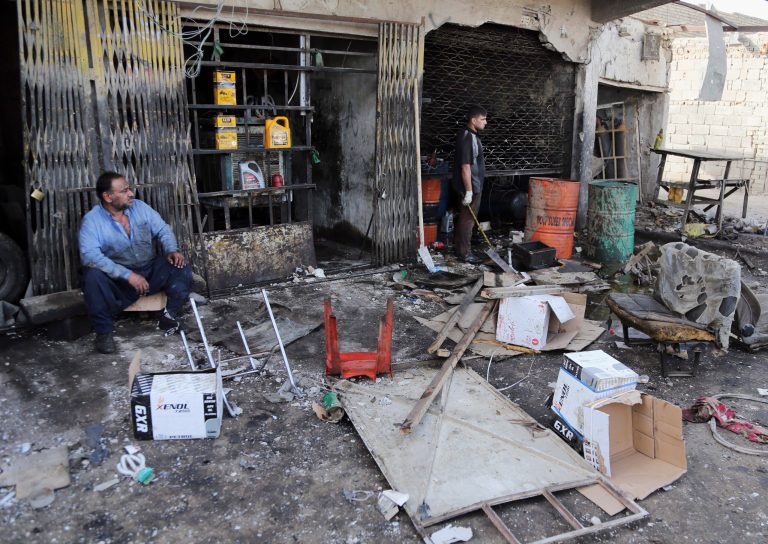 Civilians inspect the aftermath of a car bomb explosion at an industrial area in Baghdad's eastern Ur neighborhood, Iraq, Sunday, June 8, 2014. A series of car bombs exploded across Iraq's capital Saturday night, killing and wounding scores of people, in a day of violence that saw militants storm a university in the country's restive Anbar province and take dozens hostage, authorities said. (AP Photo/Karim Kadim)