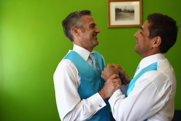 BETHESDA, MD - AUGUST 19:  TV reporter Roby Chavez (R) and his partner Chris Roe (L) share a moment as they try out their wedding tuxedos at a tailor shop August 19, 2010 in Bethesda, Maryland. Chavez of Matthews, Louisiana, and Roe, of Monticello, Wisconsin, tied the knot on August 21, 2010 in Washington, DC. Roe popped the question on the night the nation's capital became the sixth place in the U.S. to legalize same-sex marriage. Same-sex marriage will become legal in Maryland on Jan. 1.  (Photo by Alex Wong/Getty Images)