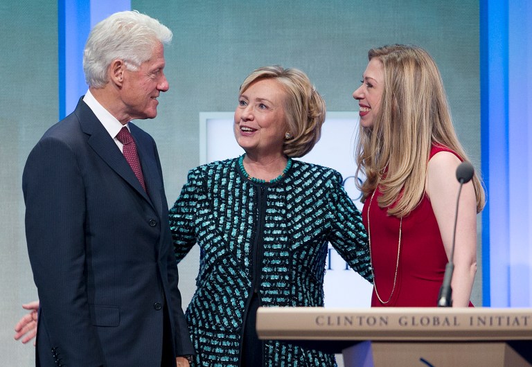 Former President Bill Clinton takes the stage with his wife, Hillary Rodham Clinton, and daughter, Chelsea, at the Clinton Global Initiative last September in New York. (AP Photo/Mark Lennihan)