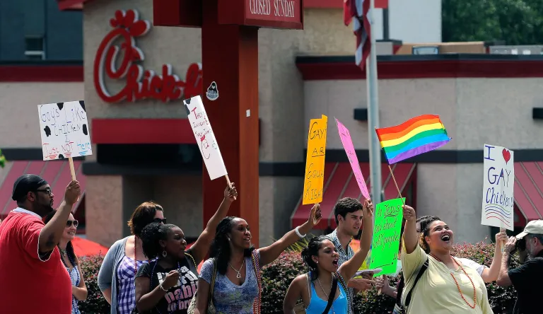 Gay rights groups and others protest and hold a "kiss-in" outside the Decatur, Ga., Chick-fil-A restaurant Friday, Aug. 3, 2012 as a public response to a company official who was quoted as supporting the traditional family unit. About two dozen protesters gathered on the busy corner to voice their views.   