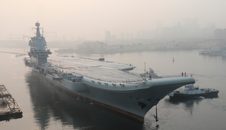 In this May 13, 2018, file photo, provided by China's Xinhua News Agency, China's aircraft carrier leaves Dalian in northeast China's Liaoning Province for sea trials.
