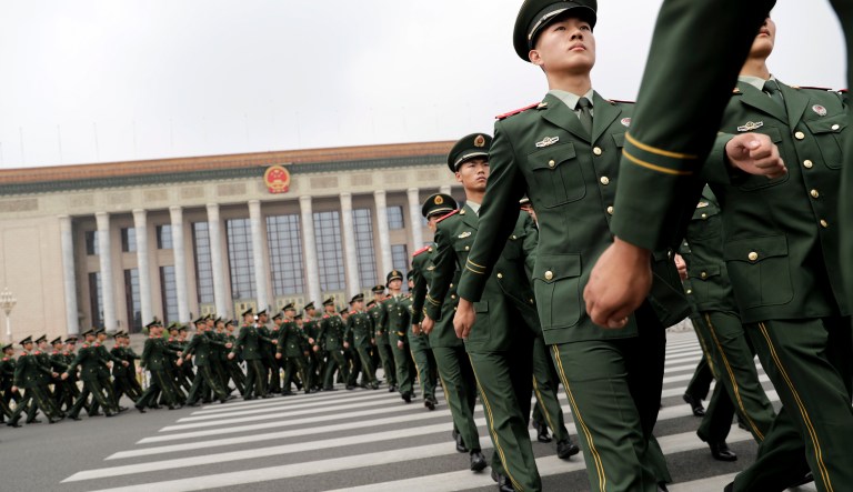 Chinese paramilitary policemen march outside the Great Hall of the People after attending a ceremony to commemorate the 90th anniversary of the founding of the People's Liberation Army in Beijing, Tuesday, Aug. 1, 2017.