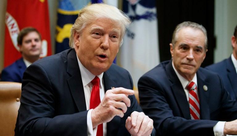 Rep. Chris Collins, R-N.Y. listens at right as President Donald Trump speaks during a meeting with members of Congress in the Roosevelt Room of the White House in Washington, Thursday, Feb. 16, 2017.