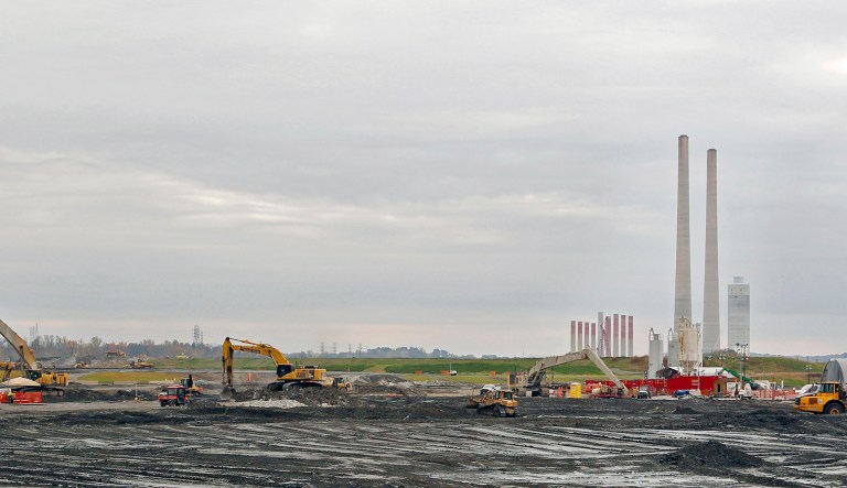 The TVA Kingston Fossil Plant can be seen in the background as heavy equipment moves ash where a massive coal ash spill took place in December 2008 is shown in this photo taken Thursday, Oct. 27, 2011 in Kingston, Tenn.