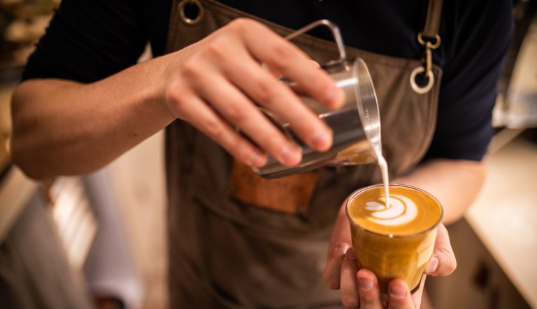 Barista make coffee cup latte art.