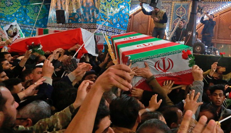 Mourners carry the coffins of Iran's top general Qassem Soleimani and Abu Mahdi al-Muhandis, deputy commander of Iran-backed militias in Iraq known as the Popular Mobilization Forces, during their funeral in the shrine of Imam Hussein in Karbala, Iraq, Saturday, Jan. 4, 2020. 