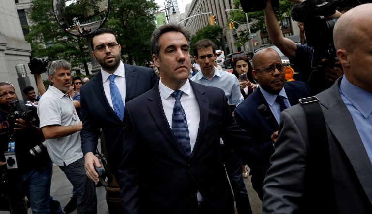Michael Cohen, personal lawyer to U.S. President Donald Trump, center, exits federal court in New York, U.S., on Wednesday, May 30, 2018. Cohen said a recent bankruptcy court ruling againstÂ Michael Avenatti's old law firm should disqualify the lawyer for Stormy Daniels from participating in a legal case over material seized from Cohen in an FBI raid.