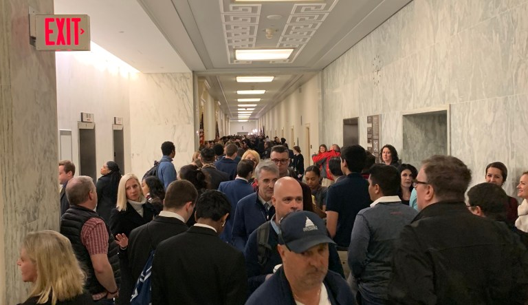 Spectators cheer AOC as they line up for four hours before Michael Cohen hearing