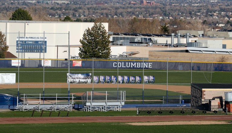 This April 19, 2019 file photo shows Columbine High School, seen from from Rebel Hill, which stands over the memorial for the victims of the massacre at the school nearly 20 years ago Friday, April 19, 2019, in Littleton, Colo.  The Jefferson County School District has abandoned a proposal to demolish Columbine and replace it after a community survey showed strong opposition to the idea. In a letter Wednesday, July 24, 2019, Jefferson County Schools Superintendent Jason Glass says the survey suggests there isnât community support to rebuild the school. The district floated Columbineâs demolition because of what Glass had called its "inspiration" for people with a dark interest in the 1999 shooting that killed 12 students and a teacher.