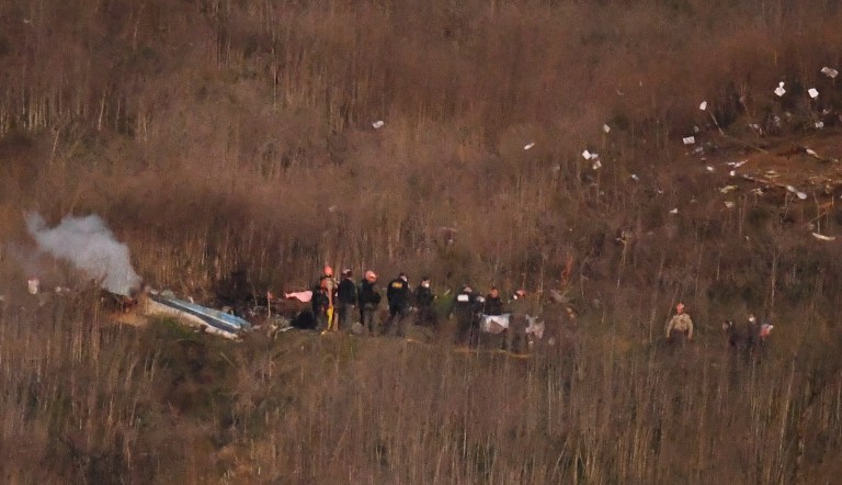 A body is moved from the scene of a helicopter crash that killed former NBA basketball player Kobe Bryant in Calabasas, Calif., Sunday, Jan. 26, 2020.