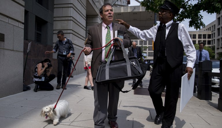Randy Credico, a New York radio host and associate of Roger Stone, center, walks with his dog outside federal court in Washington, D.C., U.S., on Friday, Sept. 7, 2018. Credico testified before a grand jury working with Special Counsel Robert Mueller's probe of Russian meddling in the 2016 U.S. presidential election.